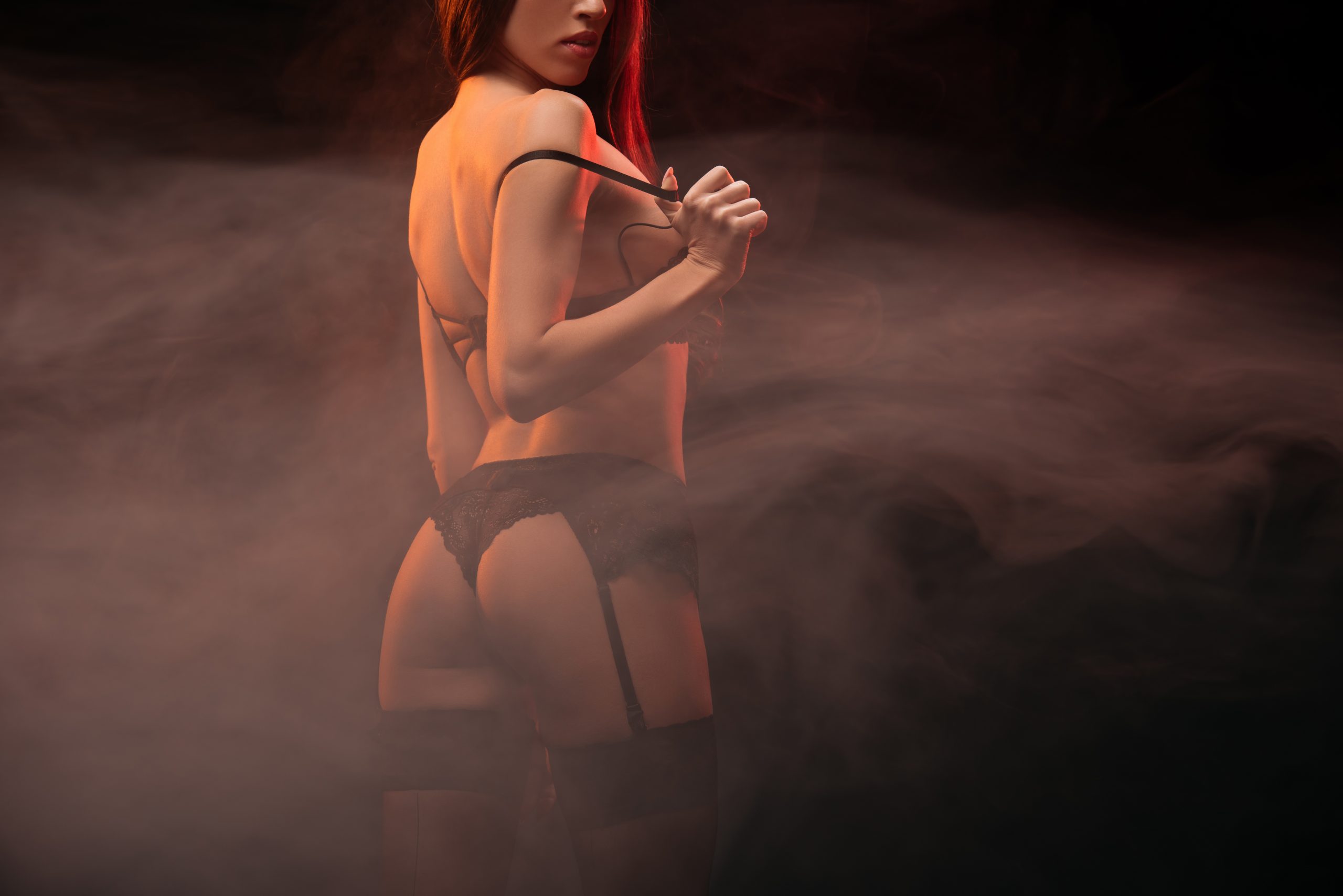 Sensual blonde performer on stage in an exclusive Riga strip club, radiating charm and confidence.