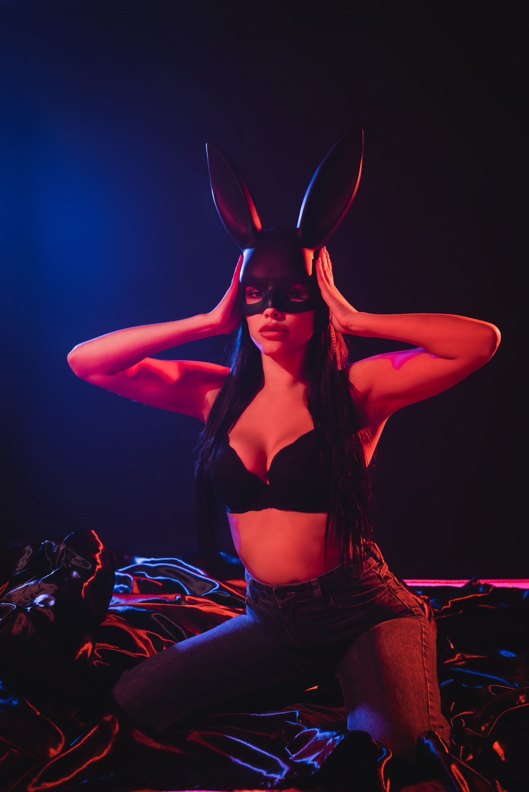 Beautiful showgirl on stage at a Riga strip club, surrounded by soft lights and an exclusive atmosphere.